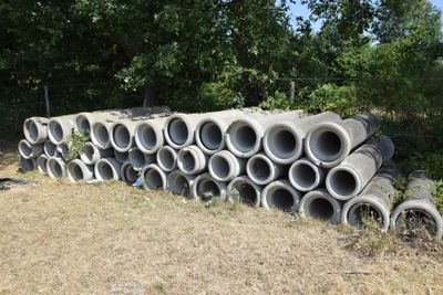 a pile of concrete pipes stacked on top of each other