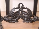 a table that has a dragon on it and a table with a vase on top of it