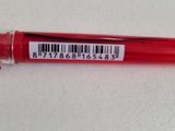 a close up of a red pen with a barcode on it