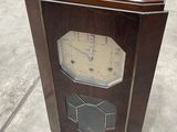 a wooden clock that is sitting on the ground