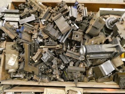 a large pile of old metal parts in a wooden box