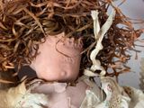 a close up of a doll with hair on it ' s head