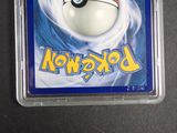 a pokemon card in a plastic container on a table
