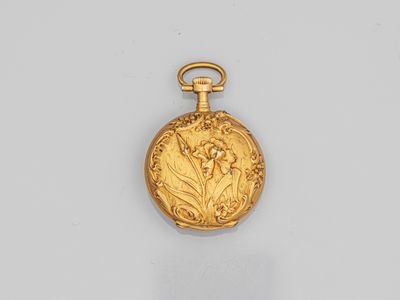 an antique gold pocket watch with a flower design on the front