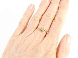 a woman ' s hand with a gold ring on it