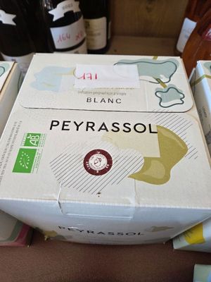 boxes of wine are stacked on top of each other on a table