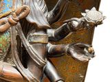 a bronze statue of a woman holding a flower