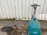 a blue machine that is sitting on the ground