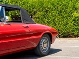 an image of a red convertible car parked in a parking lot
