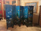 a room divider with a fish scene painted on it