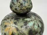 a picture of a stone sculpture of a pear on top of a rock