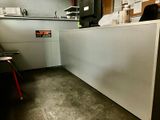 a man sitting at a counter in a restaurant