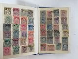 an open book with stamps on it sitting on a white surface