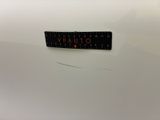 a close up of a sticker on the back of a white car