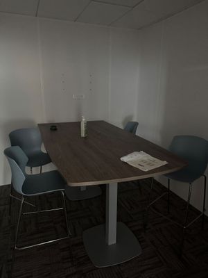 four chairs around a table in a small room