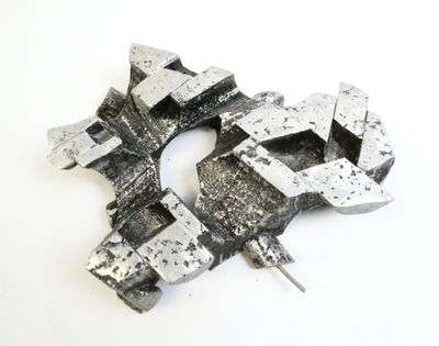 a piece of metal that has been made into a brooch