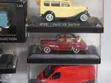 a lot of toy cars on display in a case
