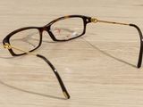 a pair of glasses sitting on a wooden table