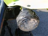 a close up of a motorcycle headlight on the front of a vehicle