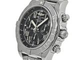 the watch is black and has roman numerals on the dial