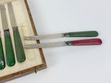 four knives and a fork in a wooden box