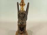 bronze figurine of an angel on a pedestal with a golden top