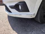 a close up of the front bumper of a white car