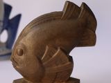a gold fish statue next to a blue and white boat