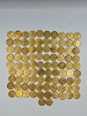 a pile of gold coins sitting on top of a white surface