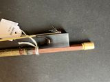 a small wooden stick with a tag attached to it