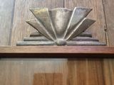a metal object on a wooden shelf on the floor
