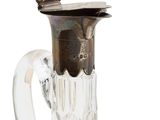 a glass vase with a metal handle on a white background