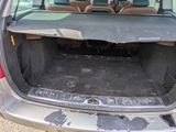 the back of a car with the trunk open and the seats down