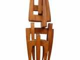 wooden sculpture of a sailboat on a wooden base on a white background