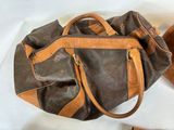 a brown purse and a brown hat on a white surface