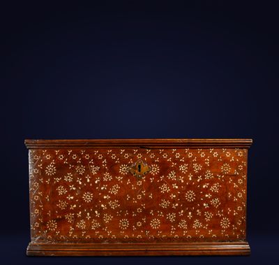 an antique wooden chest with a floral design on the front