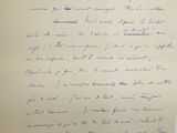 a handwritten letter on a piece of paper next to a vase of flowers