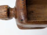 a close up of a wooden bowl on a table