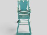 a blue high chair that is sitting in front of a gray wall