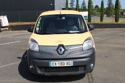 une petite camionnette jaune et grise garée sur un parking