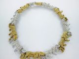 a gold and silver necklace with elephants on it