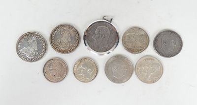 an assortment of coins are arranged in a row on a white surface