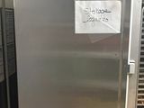 a silver refrigerator that is sitting in a kitchen
