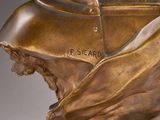 a close up of a bronze bust of a man on a marble base