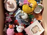 a cardboard box filled with a bunch of small toys
