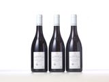 three bottles of wine sitting on top of a table next to each other