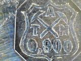 a close up of a silver coin with a coat of arms on it