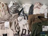 many different types of clothing on display on a table