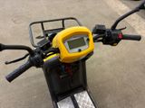 a yellow and black motorcycle parked in a parking lot