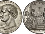 two silver coins with a portrait of a man and a woman on them